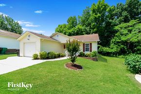 High Point house for rent - a white house with a lawn and a tree in front of it