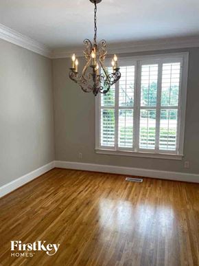 Birmingham house for rent - an empty living room with a chandelier and a window