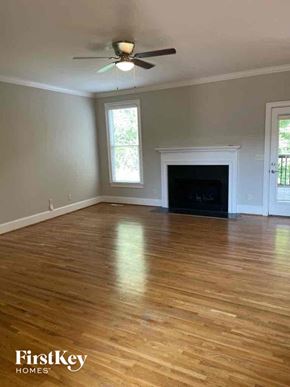 Birmingham house for rent - an empty living room with a ceiling fan and a fireplace