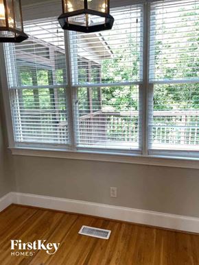 Birmingham house for rent - a living room with three windows and a wood floor