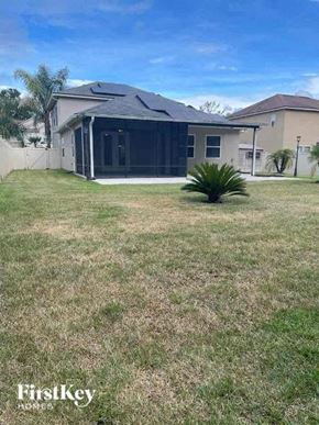 Jacksonville house for rent - a backyard with a house and a grass yard