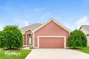 Kansas City house for rent - A house with a red garage door is for sale by FirstKey Homes.