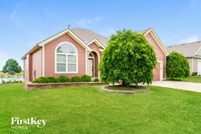 Kansas City house for rent - A red house with a tree in front of it.