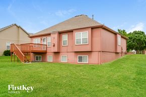 Kansas City house for rent - A house with a brown roof and a pink exterior is shown.