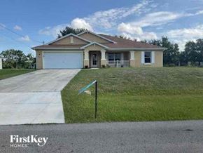 Cape Coral house for rent - a house with a driveway and a lawn
