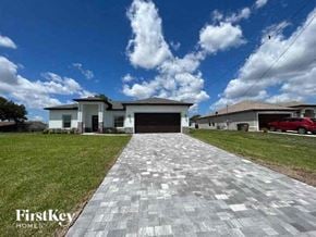 Cape Coral house for rent - a driveway in front of a house with a garage