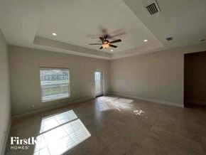 Cape Coral house for rent - an empty living room with a ceiling fan