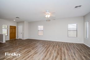 Avondale house for rent - A spacious room with wooden flooring and a ceiling fan.