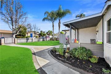 Long Beach house for rent - a walkway leading to a house with a yard and grass