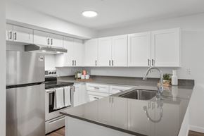 Bellevue apartment for rent - a large kitchen with white cabinets and stainless steel appliances