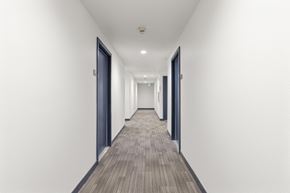 Bellevue apartment for rent - a long corridor with doors in a building