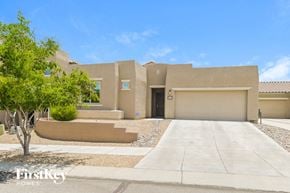 Tucson house for rent - A modern house with a beige exterior and a large front yard.