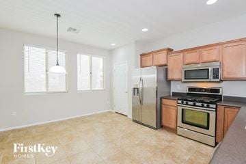 Tucson house for rent - A kitchen with a stainless steel refrigerator, microwave, and oven.