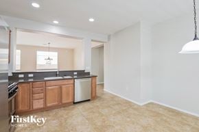 Tucson house for rent - A kitchen with a sink, stove, and cabinets.