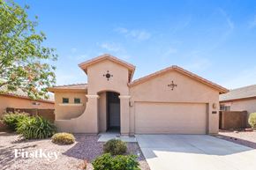 Surprise house for rent - A house with a garage and a driveway in front of it.