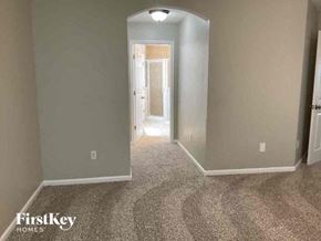 Fleming Island house for rent - a hallway with a carpeted floor and a door to a bedroom