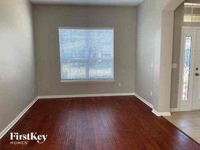 Fleming Island house for rent - a empty living room with a wood floor and a window