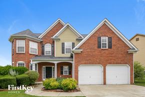 Buford house for rent - a brick house with two garage doors