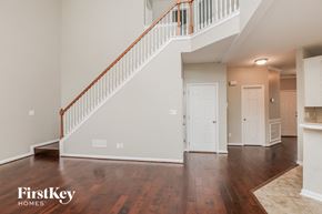 Buford house for rent - an open living room with a staircase and a white door