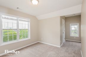 Buford house for rent - a bedroom with two large windows and a carpeted floor