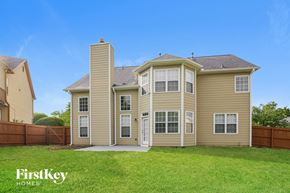 Buford house for rent - a house with a grassy yard and a wooden fence