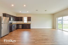 Winter Haven house for rent - A spacious kitchen with wooden floors and a refrigerator.