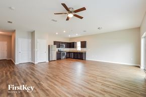 Winter Haven house for rent - A spacious room with a ceiling fan and wooden flooring.
