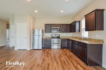 Winter Haven house for rent - A kitchen with wooden cabinets and a stainless steel refrigerator.