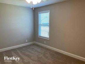 Clarksville house for rent - a bedroom with a window and a carpeted floor