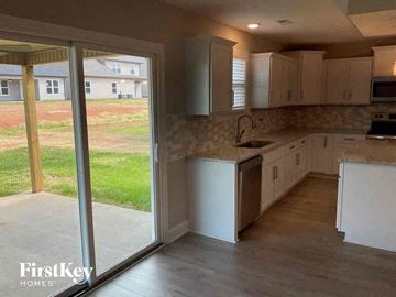 Clarksville house for rent - a kitchen with a sliding glass door to the yard