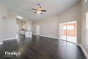 Riverview house for rent - A spacious room with a ceiling fan and wooden flooring.