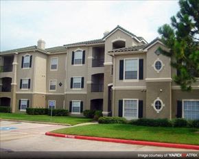 Houston apartment for rent - an apartment building with a red curb and grass