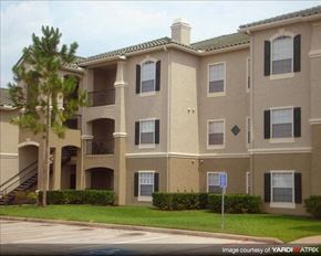 Houston apartment for rent - an apartment building with a palm tree in front of it