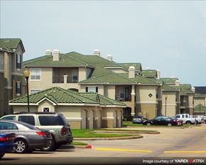 Houston apartment for rent - a group of houses with cars parked in a parking lot
