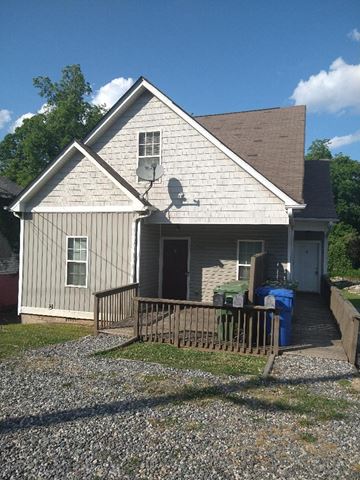 Atlanta apartment for rent - a white house with a yard and a fence
