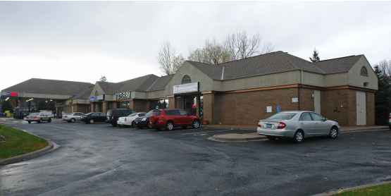 Eden Prairie apartment for rent - A parking lot with cars and a building in the background.