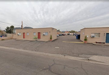 Phoenix apartment for rent - an empty parking lot with several small buildings on the side of it