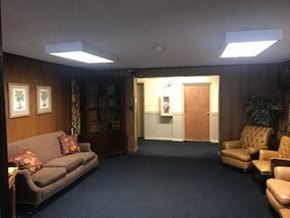 Watertown apartment for rent - a living room with couches and chairs and a door