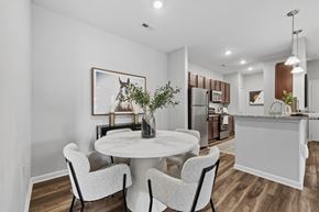 Mooresville apartment for rent - A modern kitchen with a dining table set for two.