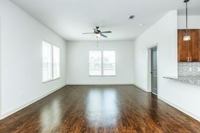 Nashville apartment for rent - A spacious room with a ceiling fan and wooden flooring.