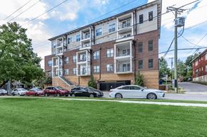 Nashville apartment for rent - A large apartment building with a parking lot in front.