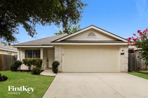 San Antonio house for rent - a white house with a driveway and a garage door