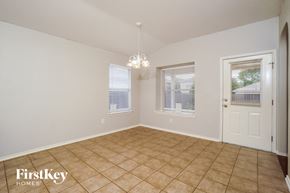 San Antonio house for rent - the dining room of a home with a tiled floor and a white door