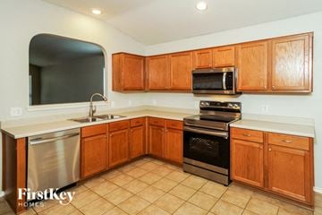 San Antonio house for rent - a kitchen with wooden cabinets and stainless steel appliances