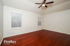 San Antonio house for rent - a living room with wood floors and a ceiling fan