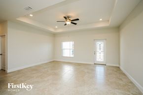 Cape Coral house for rent - an empty living room with a ceiling fan