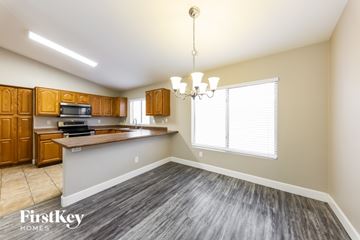 Surprise house for rent - A kitchen with wooden cabinets and a grey countertop.