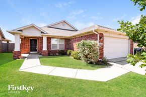 Edmond house for rent - a small brick house with a lawn and a driveway