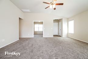 Edmond house for rent - a living room with carpet and a ceiling fan