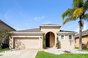 Davenport house for rent - a house with a garage door and a palm tree